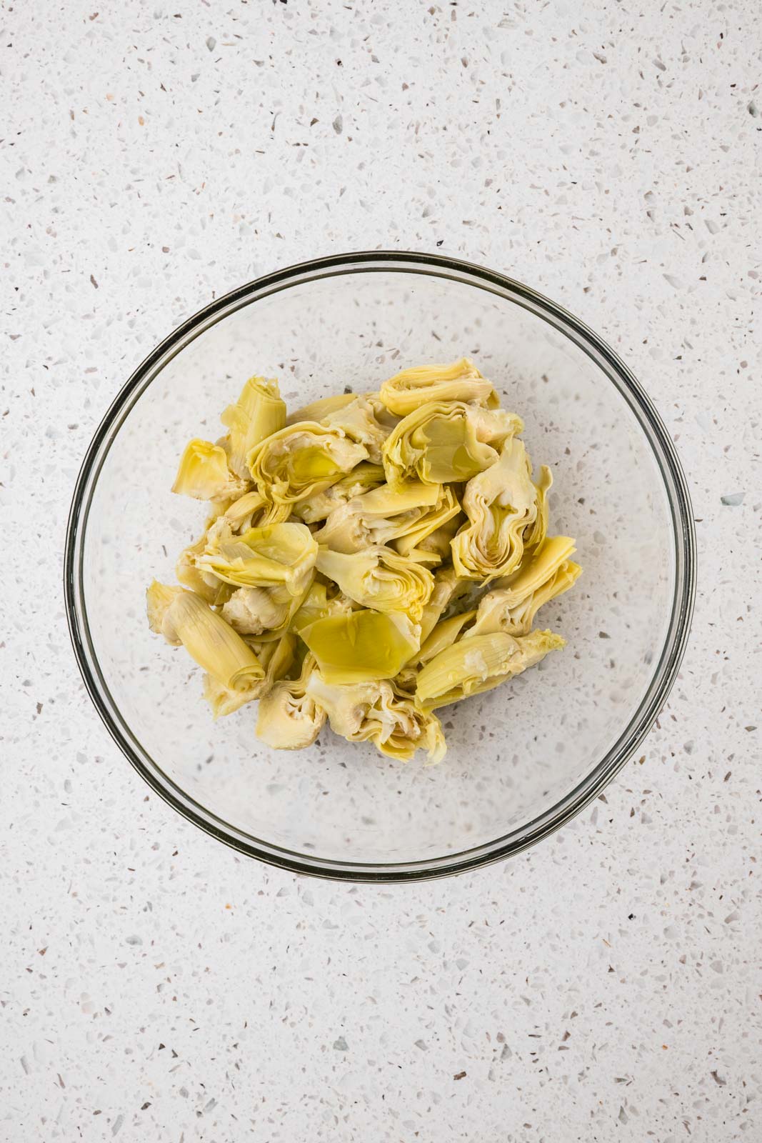 Artichoke hearts in a mixing bowl. 