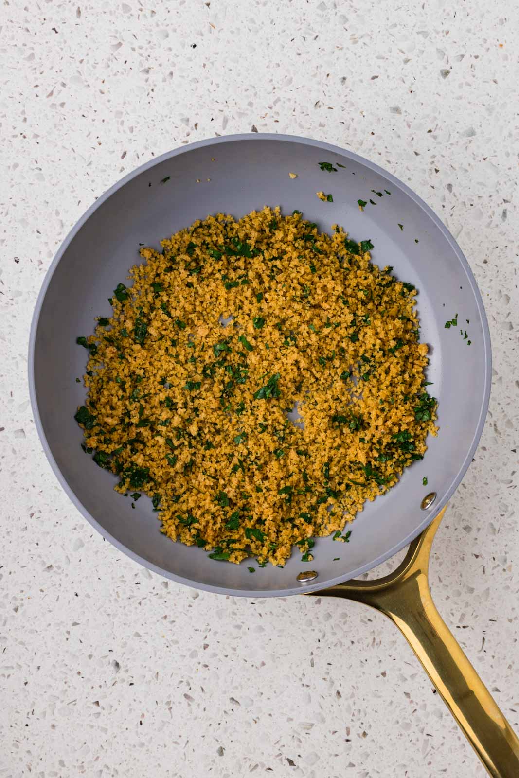 Breadcrumbs toasted in a pan.