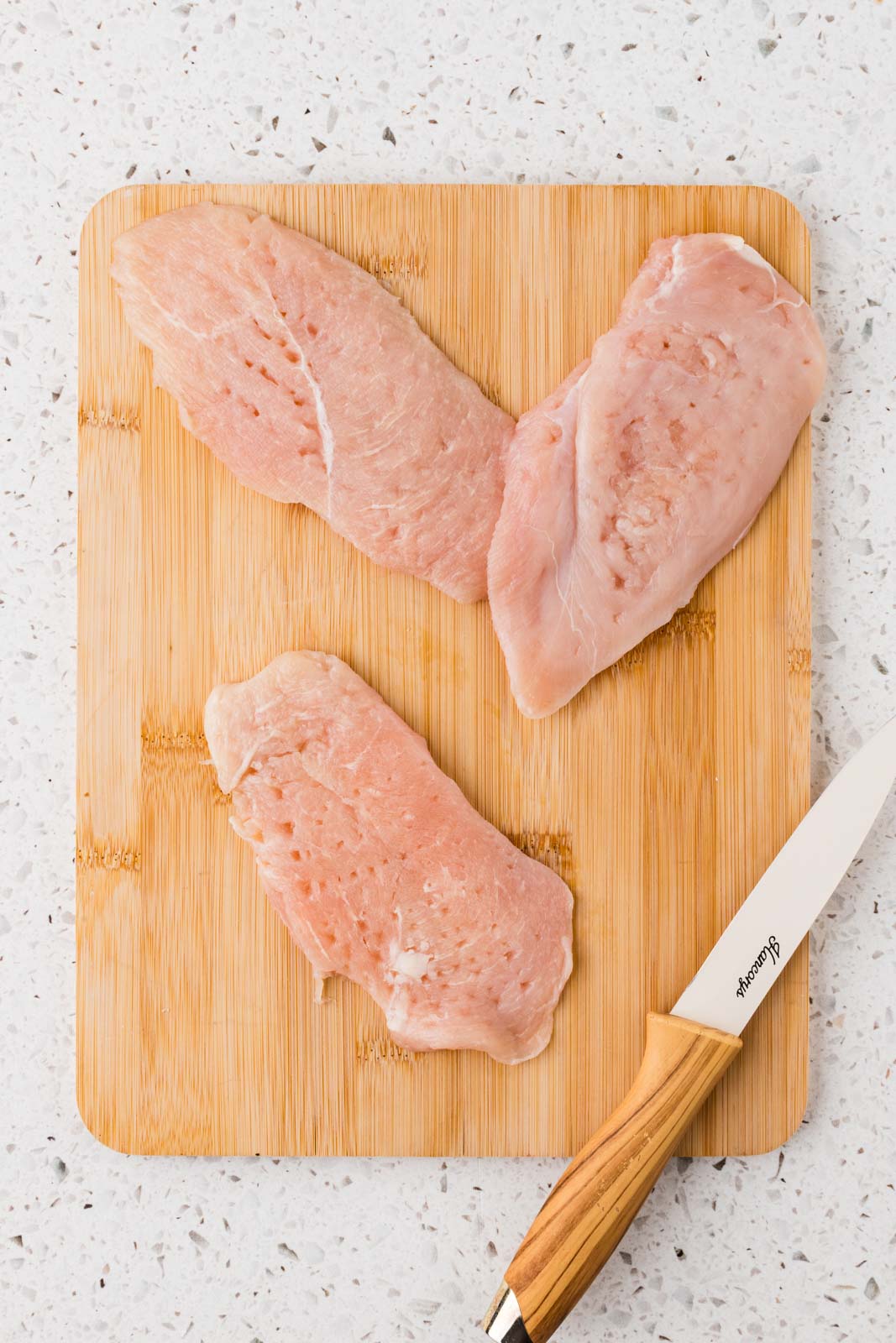 Chicken sliced and pounded.