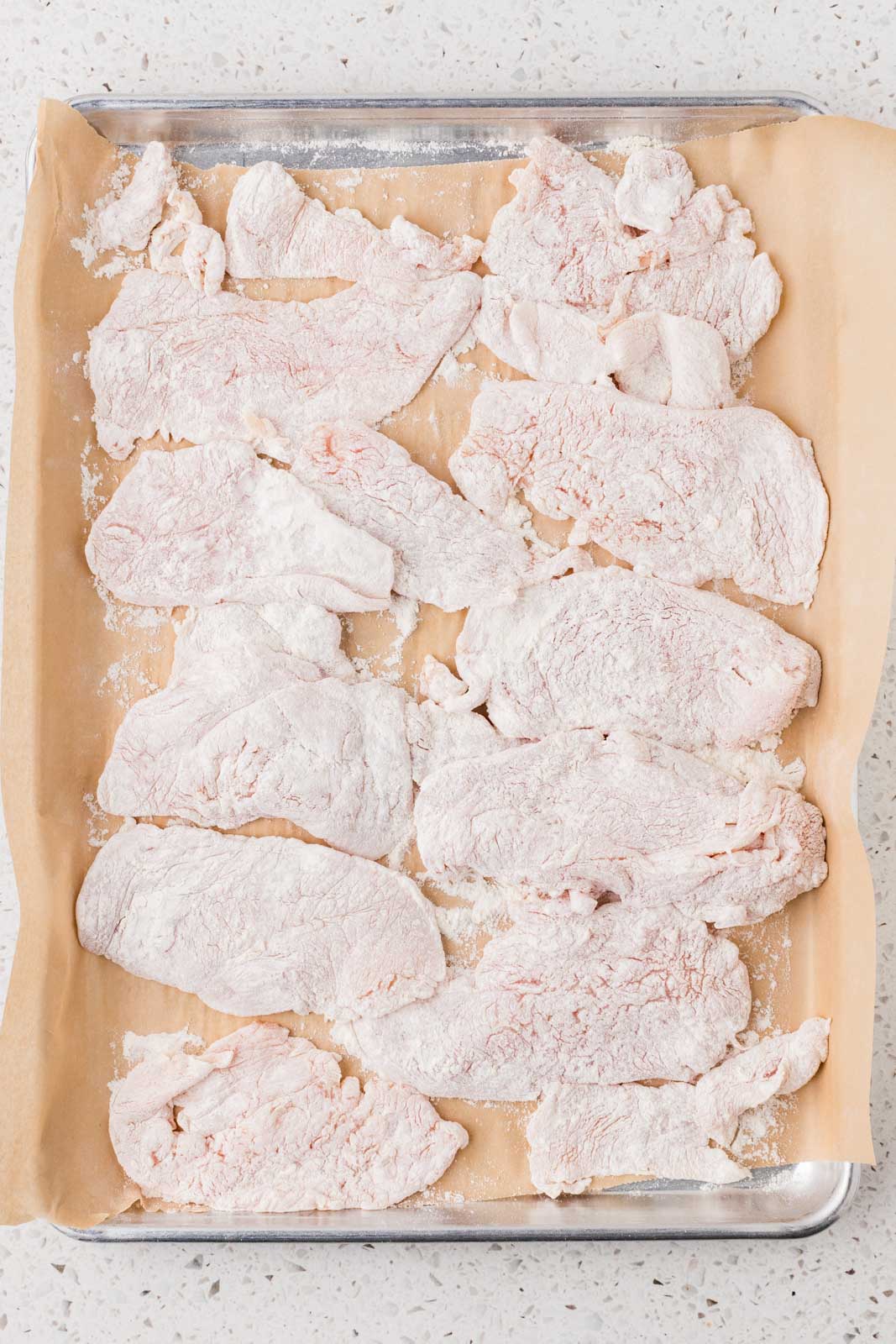 Chicken that has been floured on both sides.