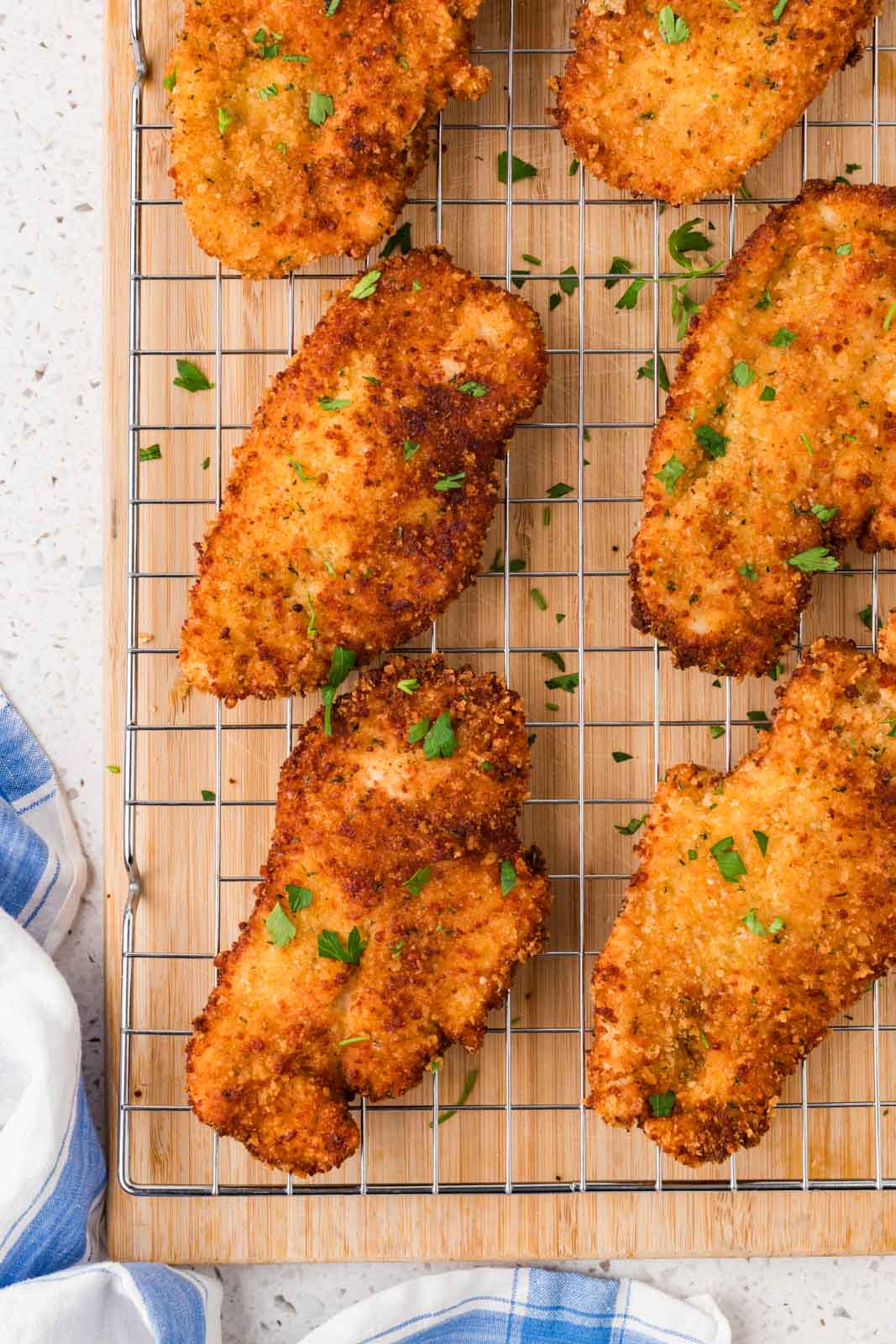 Italian chicken cutlets on a cooling rack
