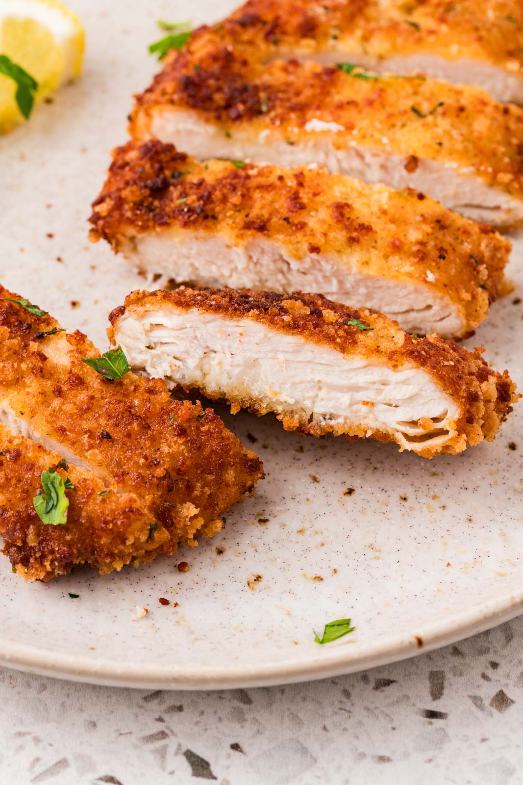 Italian Chicken Cutlet cut up on a plate.