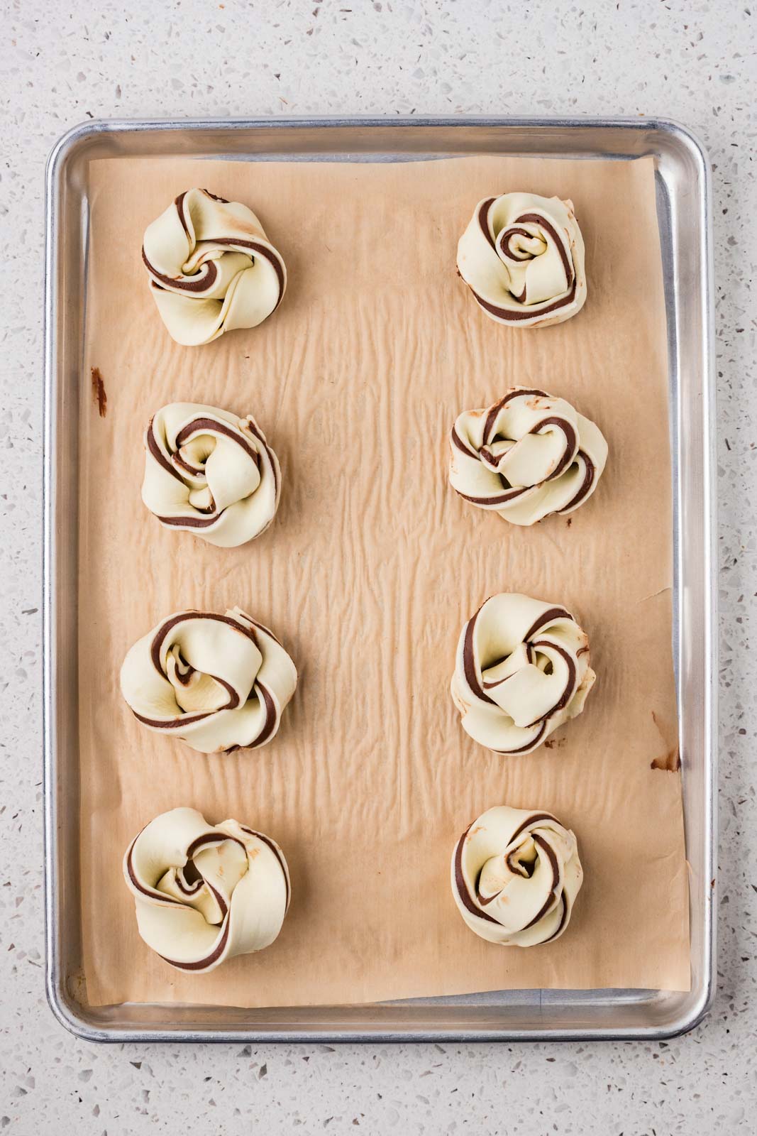 Twisted pastries on a baking sheet. 