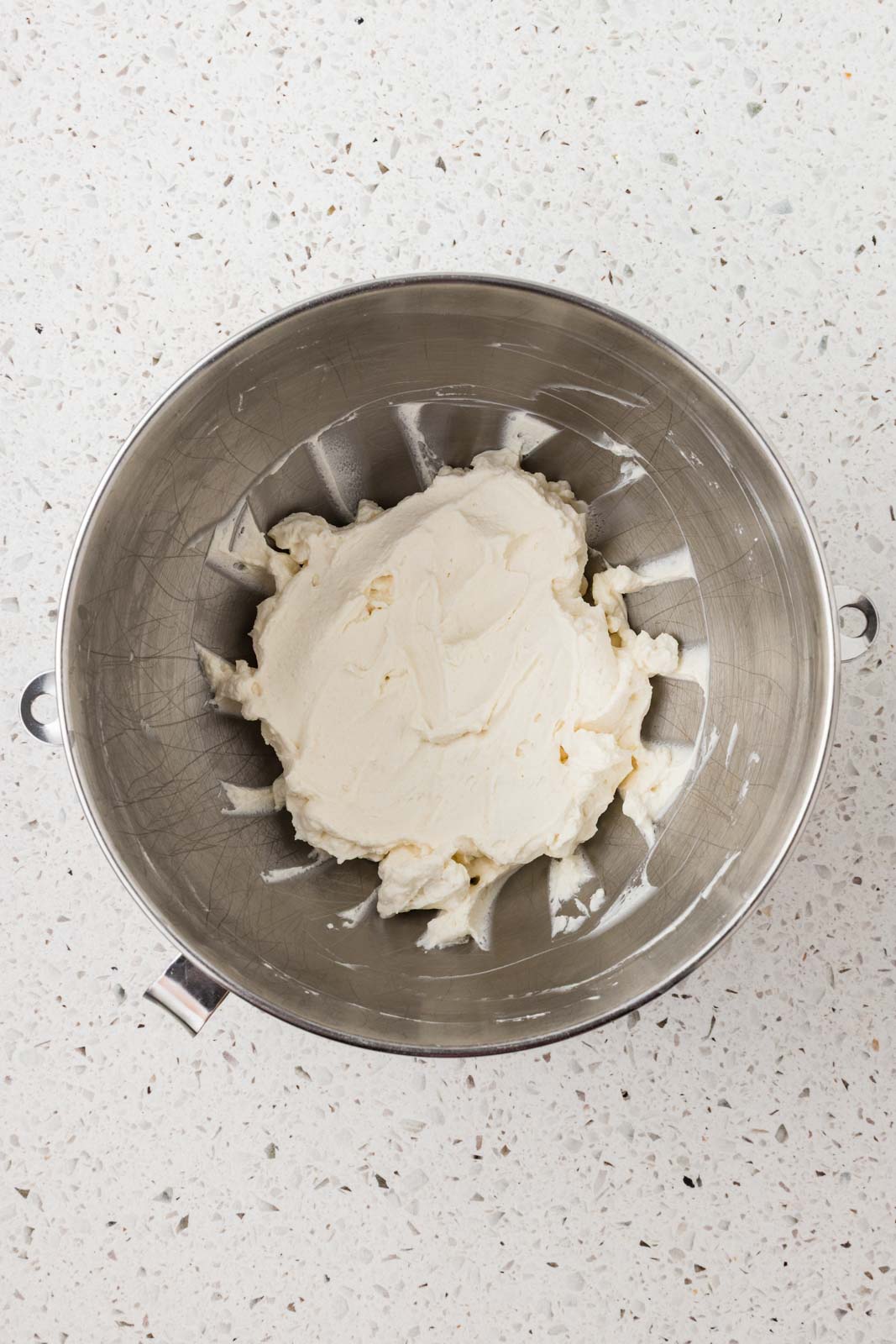 Whipped cream in a mixing bowl. 