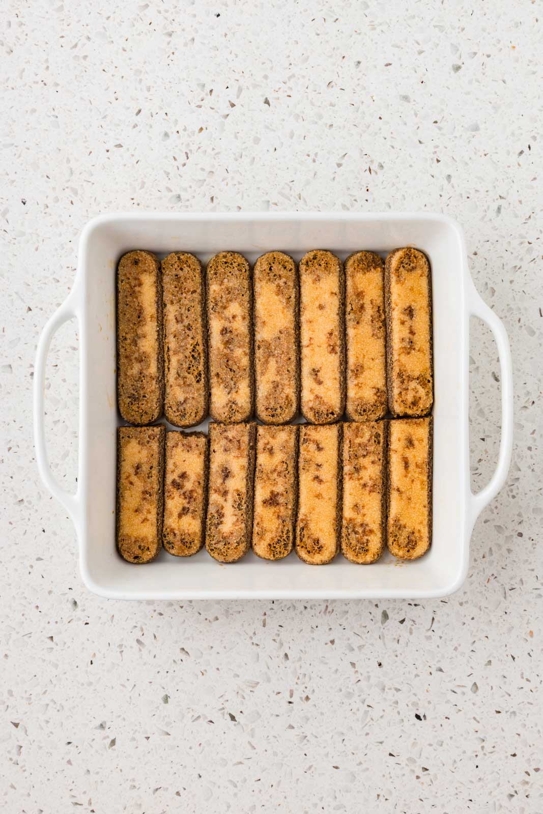 Espresso dipped lady finger in the bottom of the baking dish. 