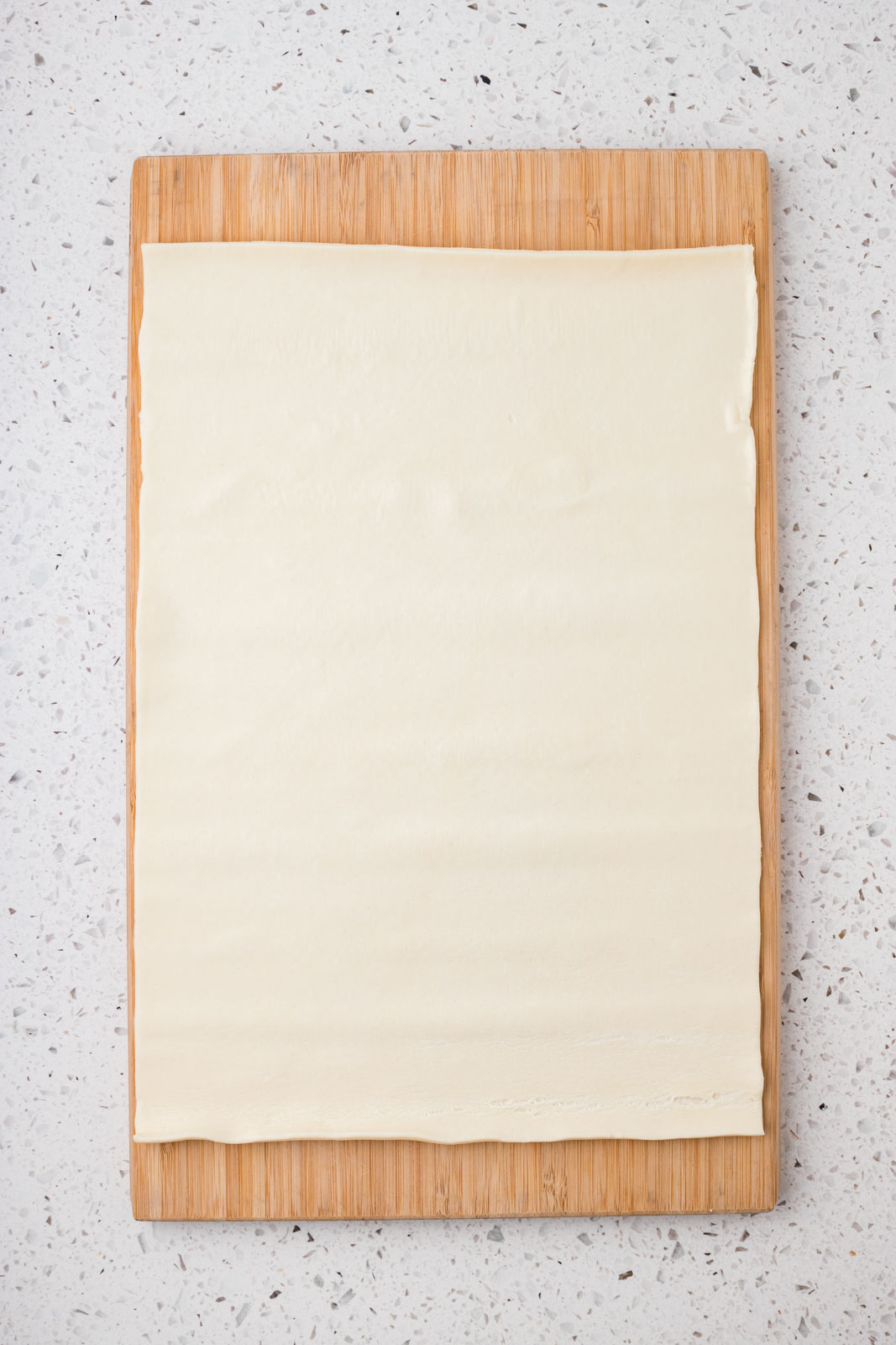 Puff pastry on a cutting board. 